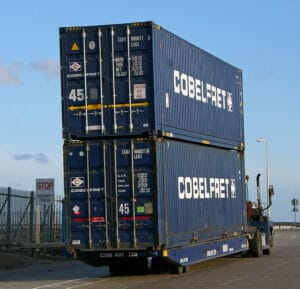 Shipping containers being moved at a customs port terminal