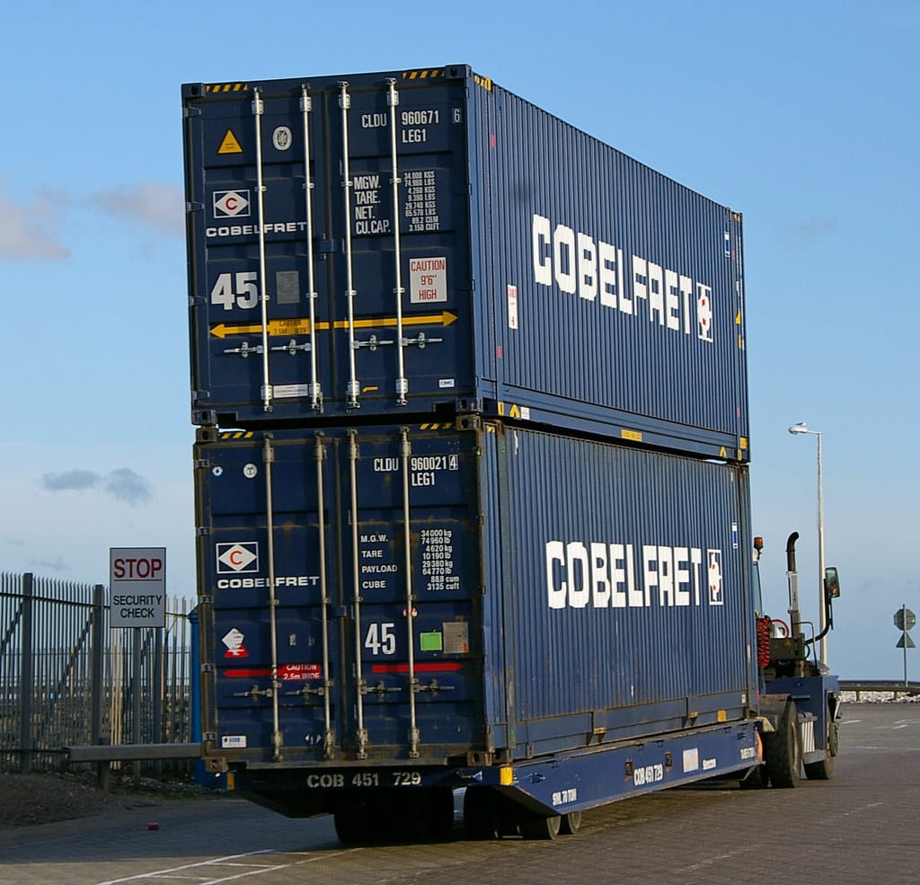 Shipping containers being moved at a customs port terminal