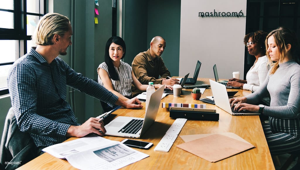 Founders reviewing a startup funding plan in a Qatar office meeting